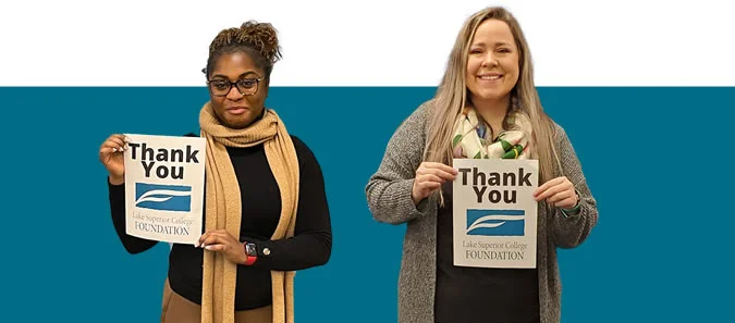 Photo of two LSC students holding Thank You signs
