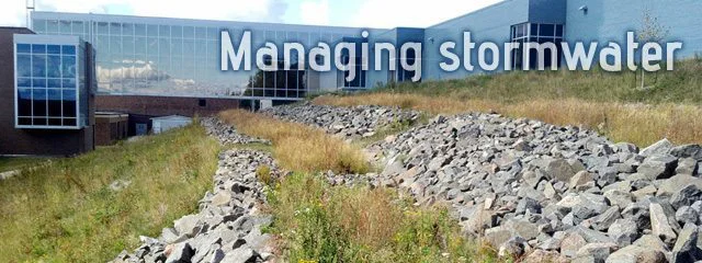 H Building showing stormwater management rock tiers on hillside