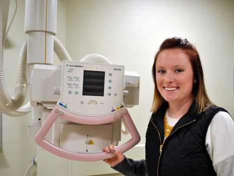 Radiologic technology student using classroom equipment