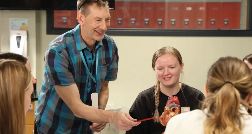 An LSC Instructor teaching a biology class with a group of students eager to learn.