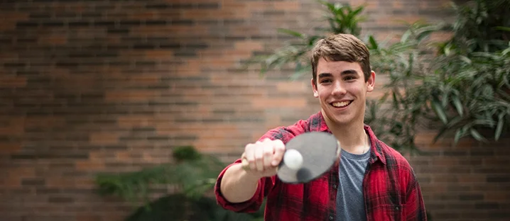 Student playing ping pong